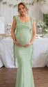 Groene zwangerschaps maxi jurk met open rug, ruches en gedrapeerde details, ideaal voor babyshower.