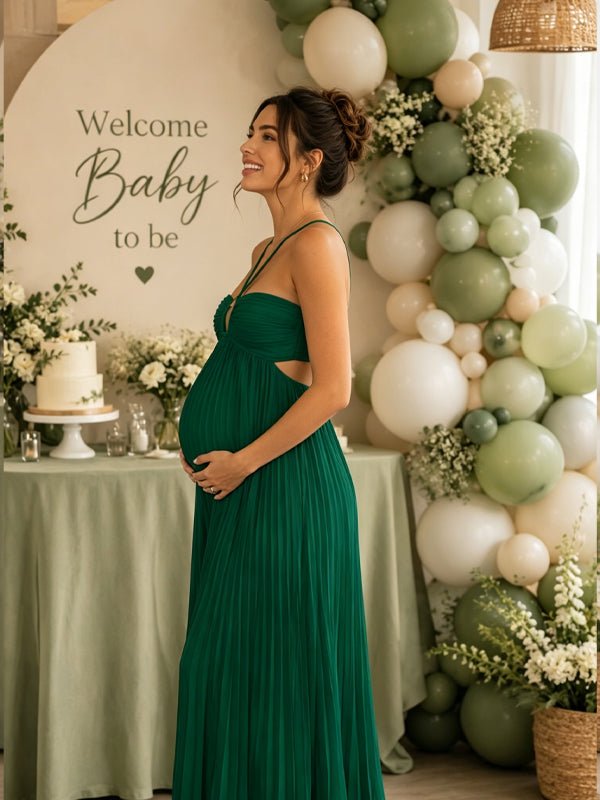 Groene zwangerschaps maxi jurk met halternek, geplooide details en open rug.