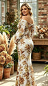 Witte zwangerschaps maxi jurk met ruches, off shoulder halslijn en zeemeermin pasvorm.