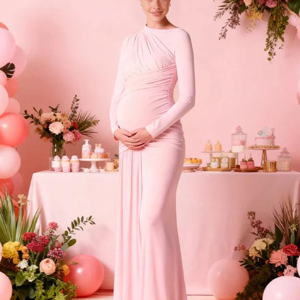 Roze zwangerschaps maxi jurk met gedrapeerde bodycon pasvorm.