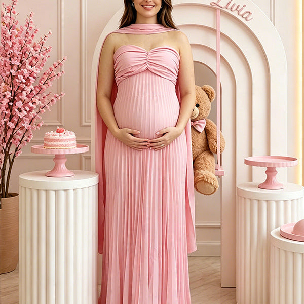Vooraanzicht van een roze zwangerschapsjurk voor een babyshower