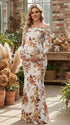 Witte zwangerschaps maxi jurk met off shoulder halslijn, print en ruches in een zeemeermin silhouet voor party.